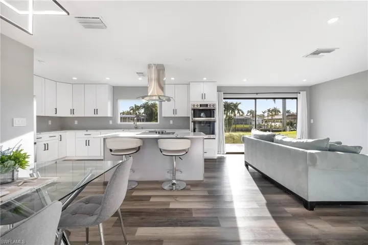 Kitchen featuring plenty of natural light, island exhaust hood, and visible vents
