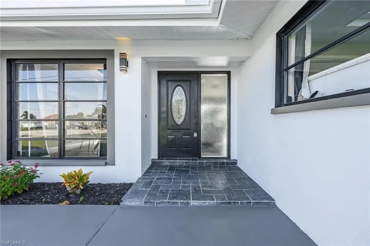 Doorway to property with stucco siding