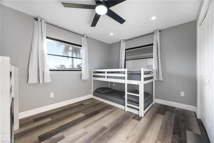 Unfurnished bedroom with recessed lighting, baseboards, wood finished floors, and a ceiling fan