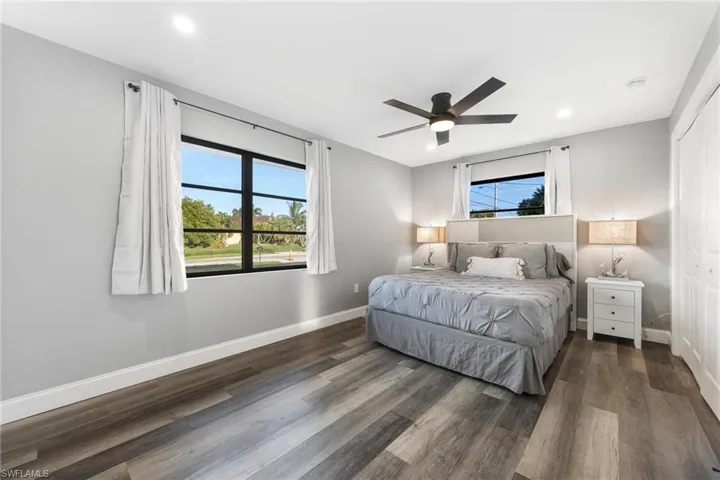 Bedroom featuring recessed lighting, baseboards, multiple windows, and wood finished floors