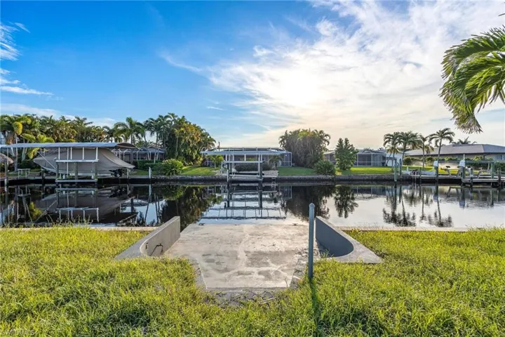 Dock area with a yard, a water view, and boat lift