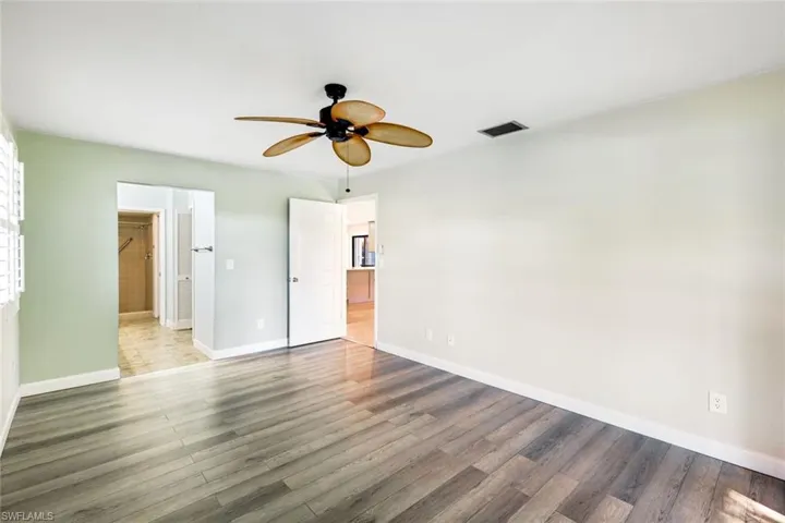 Master bedroom with tropical ceiling fan leading to the very large master bath area.