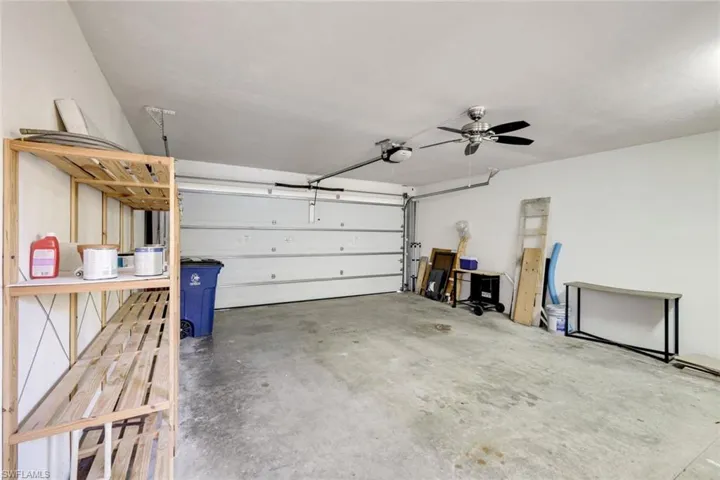 2 car garage with opener and an extra French door refrigerator and stack front load washer and dryer.  Extra storage shelving and access to the outdoor patio!