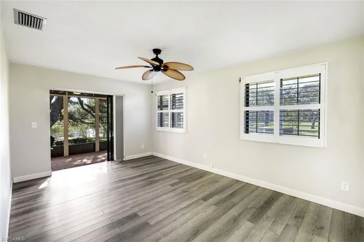 Master bedroom has sliders to the private and oversized screened lanai, plantation shutters throughout!