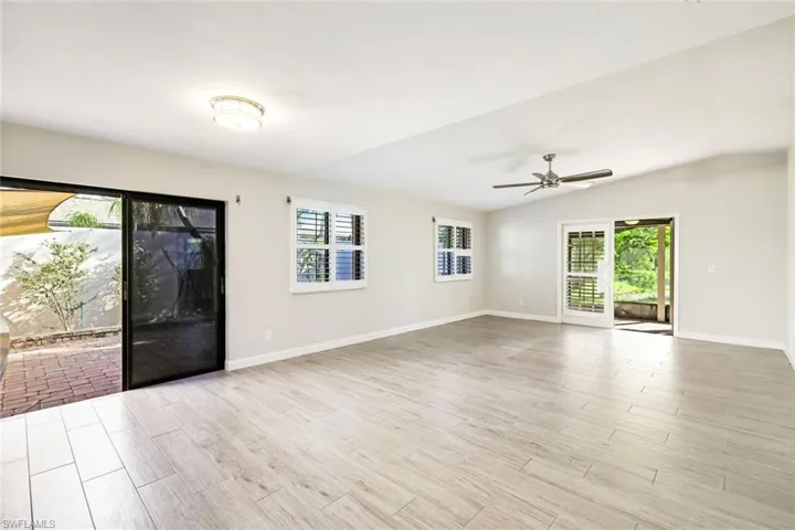 Living area from the kitchen with sliders to the private open patio and garden AND the huge, screened lanai!