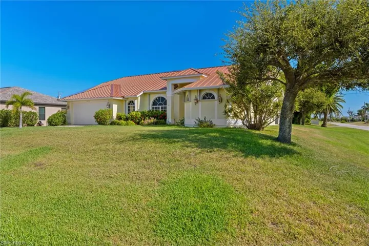 Mediterranean / spanish-style house with a front yard