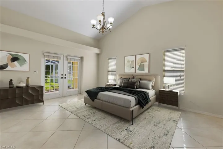 Virtually staged.  Tiled bedroom featuring high vaulted ceiling, french doors, a chandelier, and access to exterior