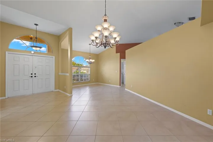 Tiled foyer with a notable chandelier