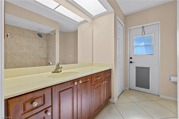 Bathroom featuring tile flooring and vanity