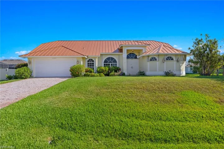 View of front of home with a garage and a front yard