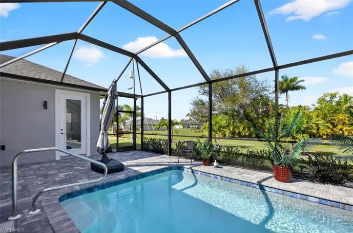 Swimming pool featuring a sunroom and glass enclosure