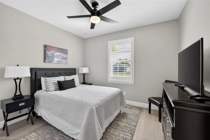 Bedroom with wood finish floors and a ceiling fan