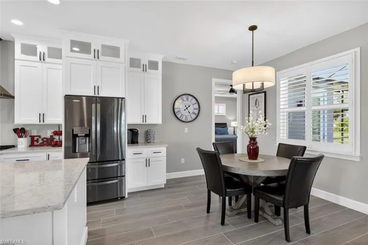Dining area featuring wood tiled floors and a ceiling fan