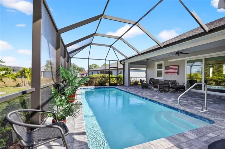 Outdoor pool with a sunroom, a lanai, and a patio area