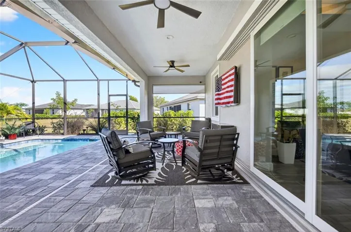 View of patio / terrace with a sunroom, glass enclosure, and ceiling fan