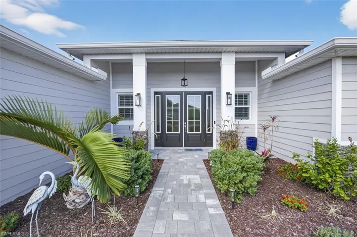 Entrance to property featuring a porch and french doors