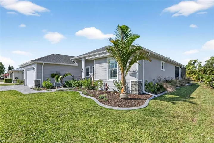 View of front of house featuring a front lawn, an attached garage, driveway, and a shingled roof