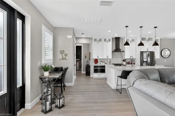 Living room with wood tiled floors and recessed lighting