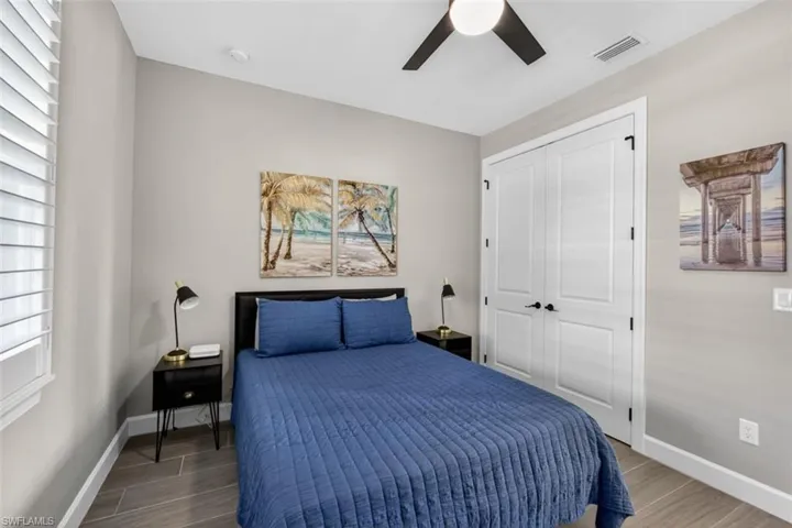 Bedroom with wood finish floors, a ceiling fan, and a closet