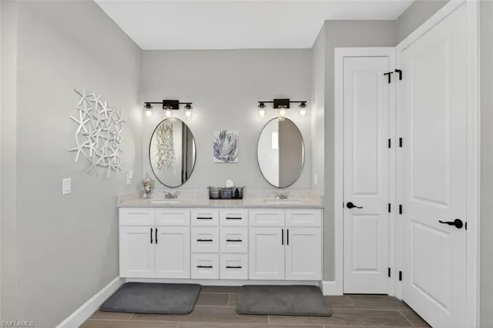 Full bathroom with wood tiled floors and double vanity
