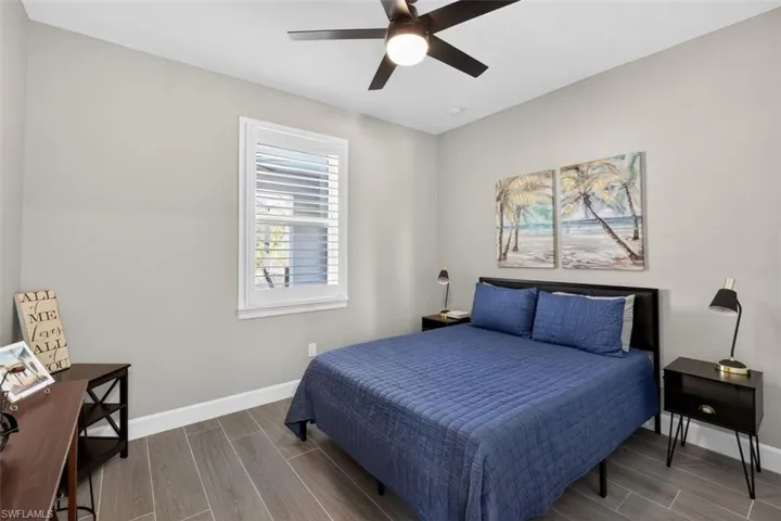 Bedroom featuring wood finish floors and ceiling fan