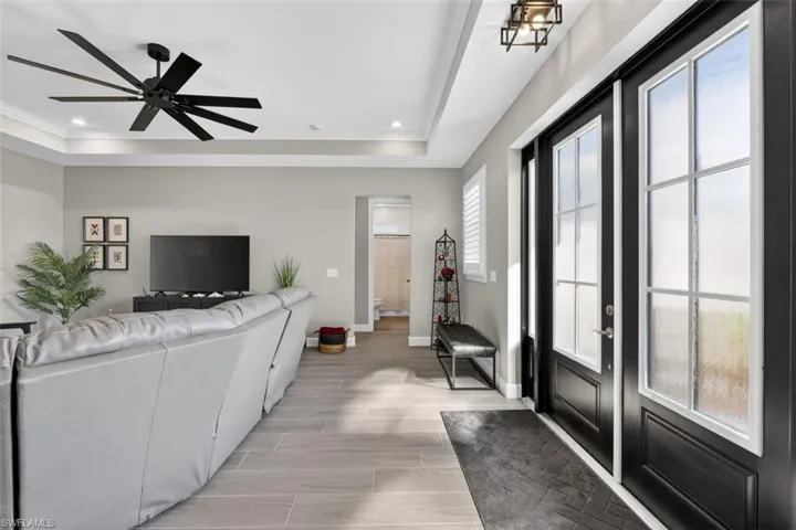 Living room featuring wood tiled floors, recessed lighting, and ceiling fan
