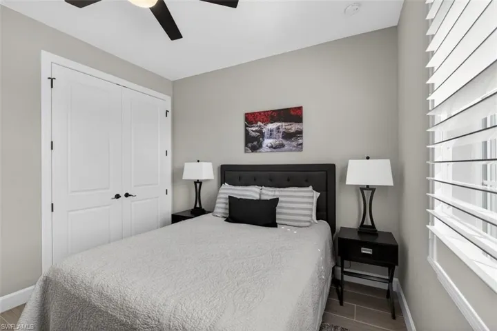 Bedroom with a closet, ceiling fan, and wood finished floors