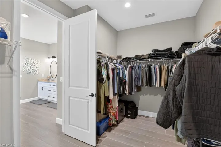 Walk in closet featuring wood tiled floors