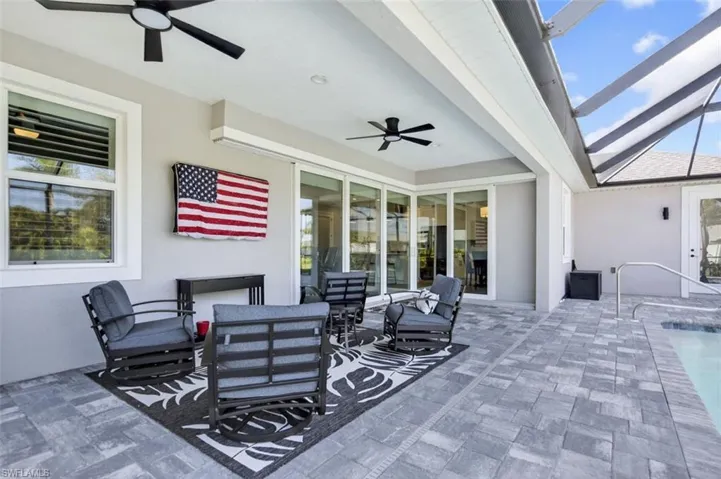 View of patio featuring ceiling fan, an outdoor pool, outdoor dining space, outdoor lounge area, and glass enclosure