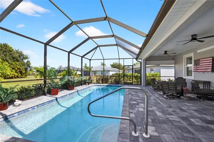 Outdoor pool featuring a sunroom, a lanai, and a patio