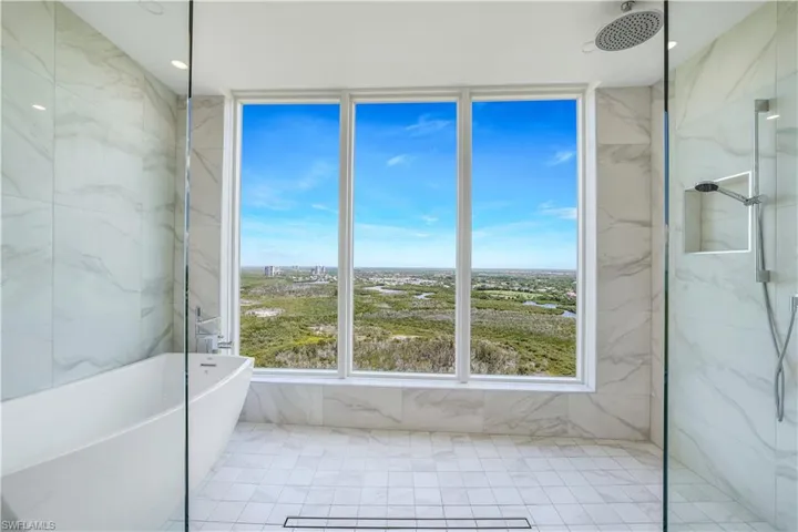 Primary en suite with large shower and soaking tub.