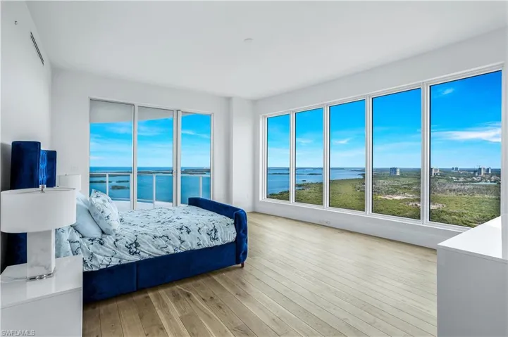 Primary bedroom with lanai access overlooks the Western sky. Imagine waking up to this view each day!