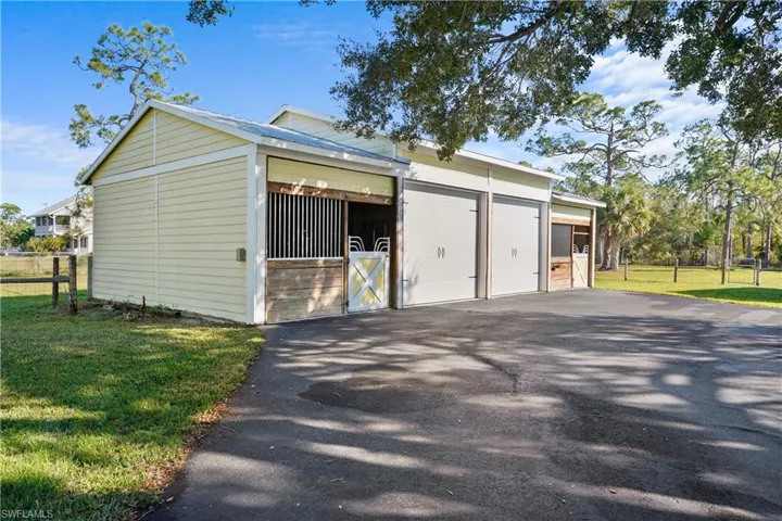 Barn features oversized garage with two double stalls that could be made into 4 stalls. Double doors in back of stalls open to fenced and crossed fenced pasture.