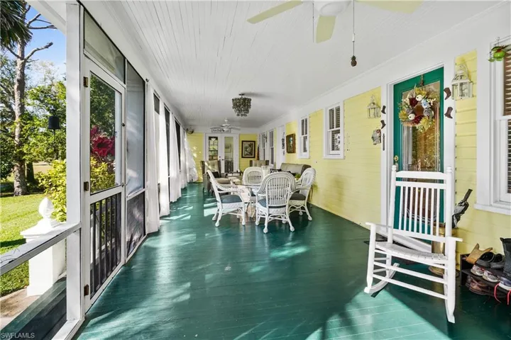 Front screen Porch with with ceiling fans entry to kitchen/dinning room and french doors to guest bedroom.