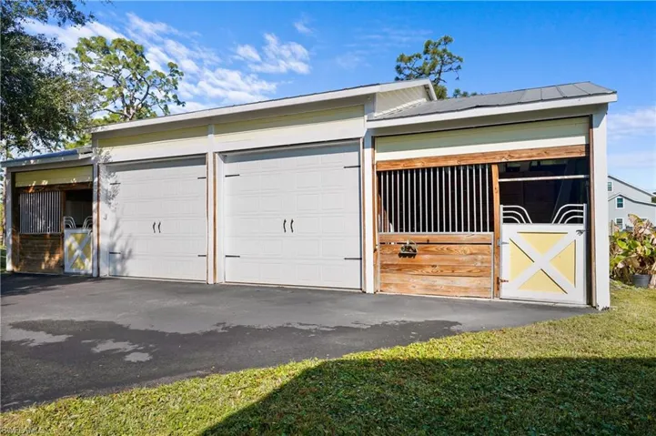 Beautiful stalls will make you and your horses very happy! Barn also features lover sized garage with over sized garage doors.