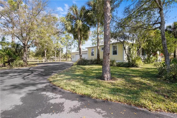 View of front of house as your entering attached garage and airconditioned studio are to the left to the right you will aproach the front of the home and cirlce drive with out buildings, pool and pool house.