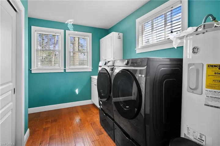 Laundry room with sink and large storage closet / 2nd pantry hand scraped hardwood floors, cabinets washer / dryer hook-ups.