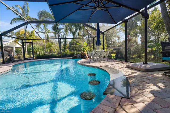 Pool has built in bar stools and granite top.