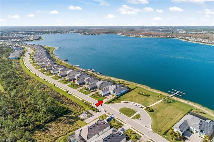 Aerial perspective of suburban area with a nearby body of water