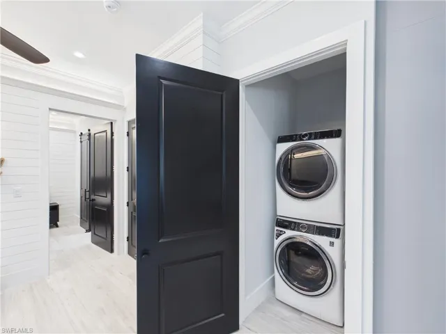 Stacked washer and dryer unit within a dedicated closet