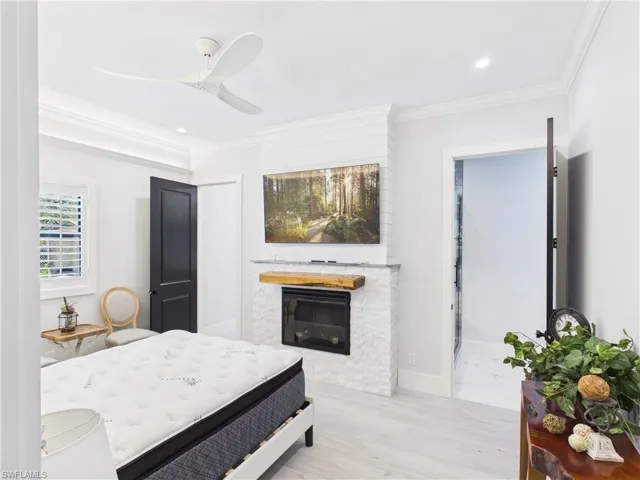 Fireplace featuring a stone facade and a live-edge wood mantel