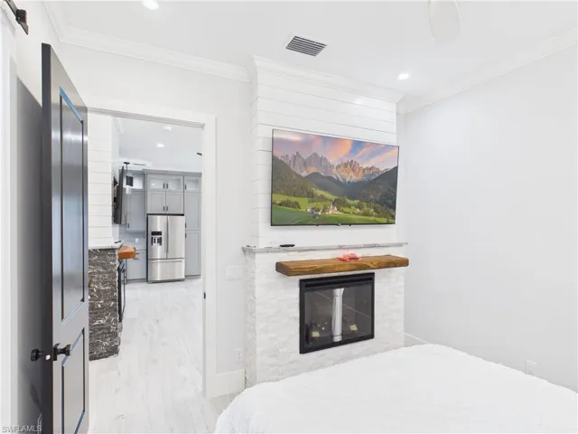 Built-in fireplace with a stone facade and rustic wood mantel