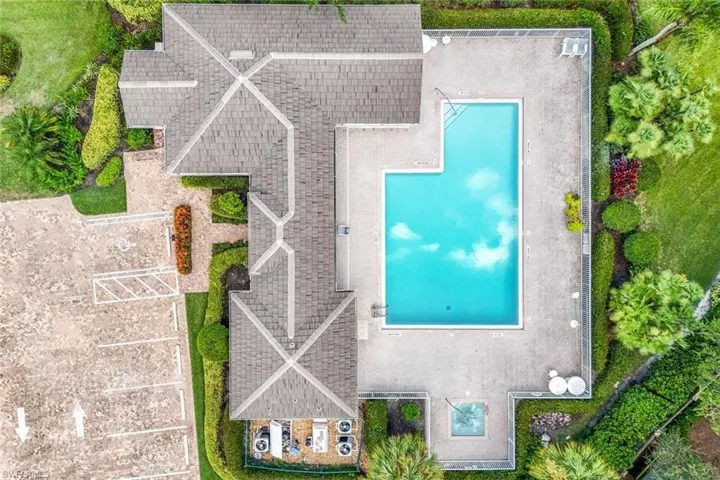 Sparkling community pool with ample seating.