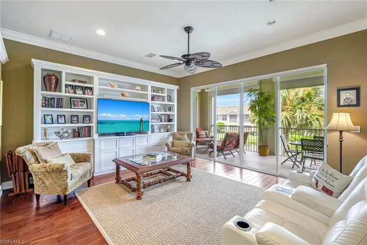 Bright, spacious living area with hardwood floors and serene lake views.
