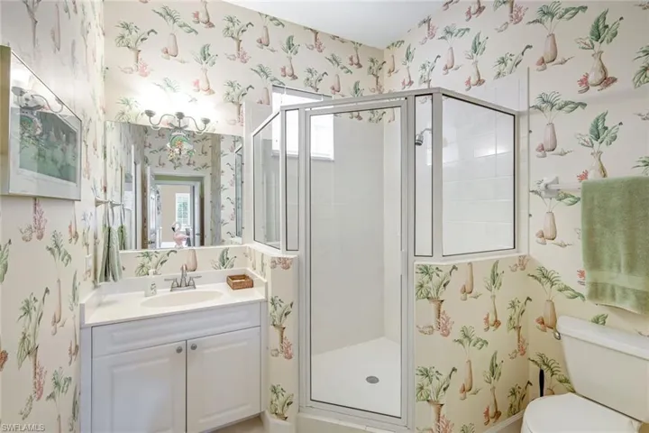 Second guest full bath with glass shower and vanity.