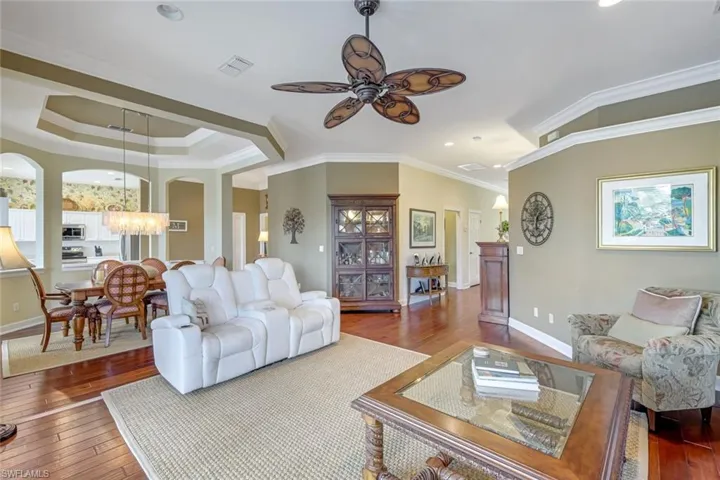 Open-concept family room with crown molding and natural light.