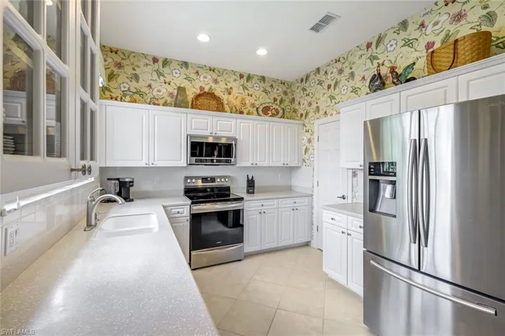 White cabinetry, stainless appliances and plenty of space for a few chefs!