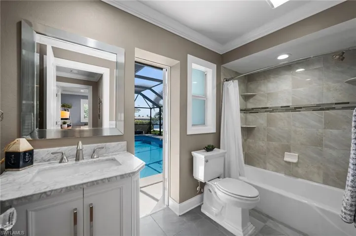 Main Bathroom with access to the pool and tub/shower combo.