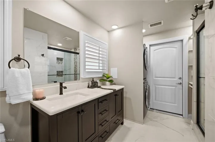 Junior Suite/ Bedroom #2's  bathroom with laundry room and access to garage.