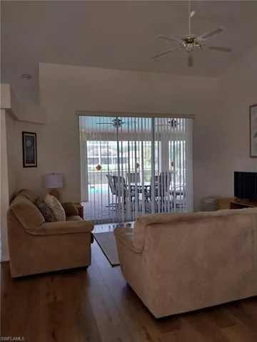 Living area featuring wood finished floors and a ceiling fan